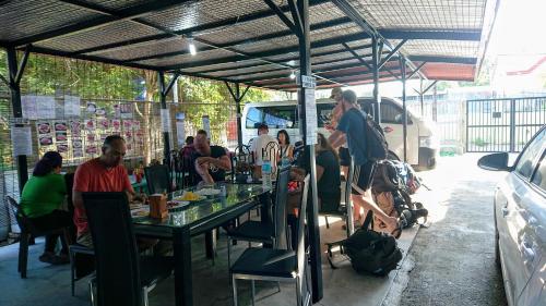 a group of people sitting at a table under a tent at Prince Transient house in San Jose