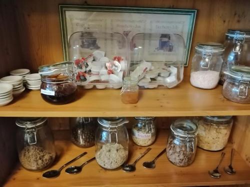 a shelf filled with jars of food and spoons at Sauerland-Hotel in Essentho