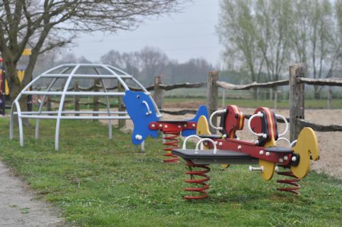 a row of playground equipment in a park at Wilgenwind in Sijsele