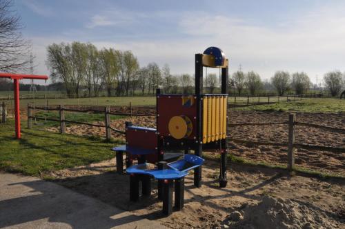 a playground in a park with a slide at Wilgenwind in Sijsele