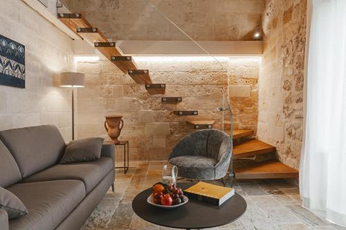 a living room with a couch and a table at Cenobio Hotel & SPA Matera in Matera