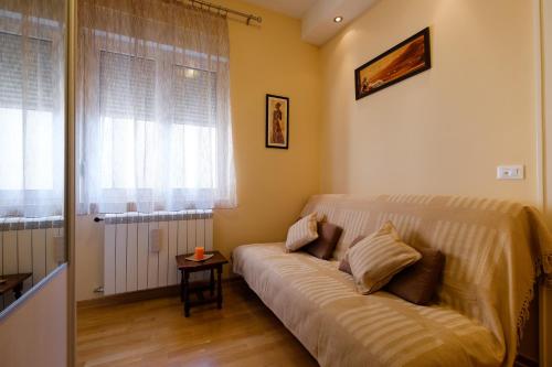 a living room with a couch and a window at Jolie in Belgrade