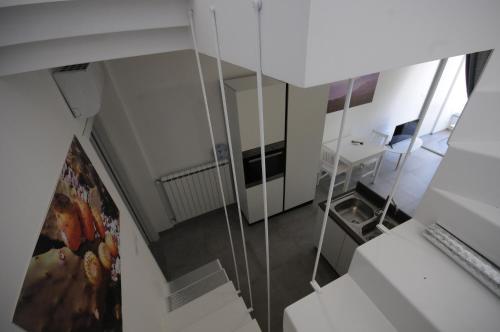 a room with a staircase with a desk and a mirror at Appartamenti porta mare in Otranto