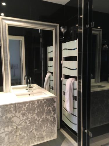 a bathroom with a sink and a mirror at LOFT Le MARELLA in Royan