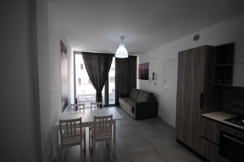 a living room with a couch and a table and chairs at Appartamenti porta mare in Otranto