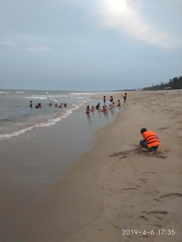 a group of people playing in the sand on the beach at The Natural Bungalow in Hoi An