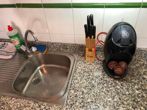 a kitchen counter with a sink and a tea kettle at Two bedroom apartment 2 min from beach in Mogán