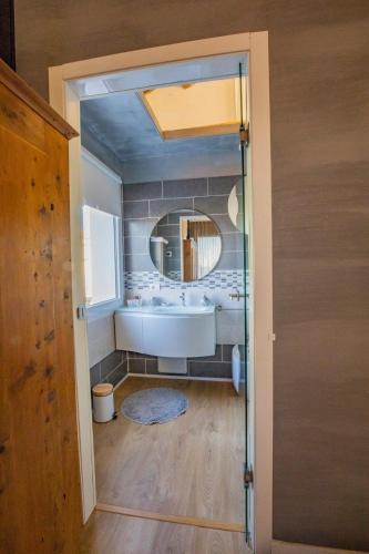 a bathroom with a sink and a mirror at A casa di V-Ale in Treviso