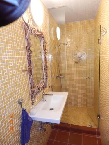 a bathroom with a sink and a shower at Villa with swimming pool and tennis/basketball court in Theológos