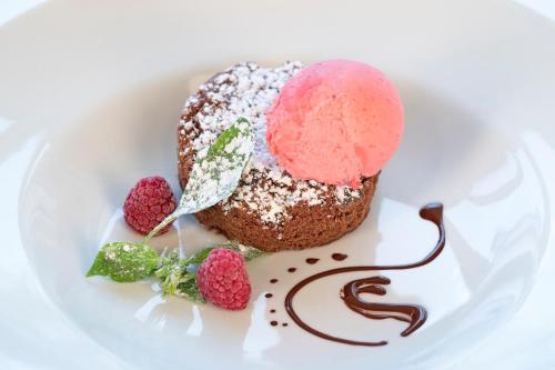 a dessert with a pink ice cream on a white plate at Hotel & Gutsgasthaus Köberle in Lindau