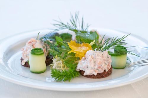 a white plate of food on a white plate at Hotel & Gutsgasthaus Köberle in Lindau