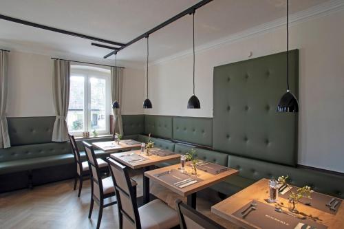 a dining room with wooden tables and chairs at Hotel & Gutsgasthaus Köberle in Lindau