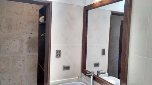 a bathroom with two sinks and a large mirror at Acolpacha Tambo Boutique in Arequipa