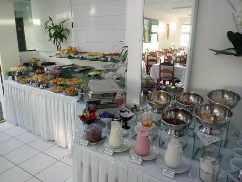 a buffet of food on a table in a restaurant at Hotel Nautico in Guaratuba