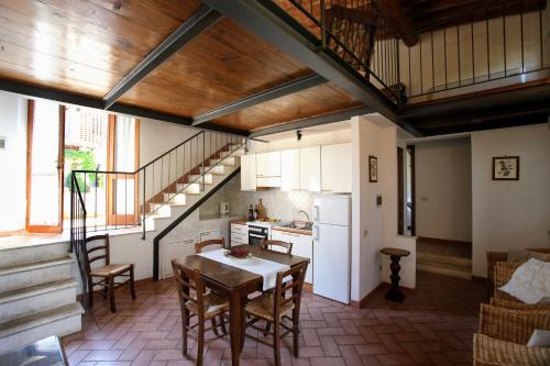 a kitchen with a table and chairs in a room at L'Aia Country Holidays in Siena