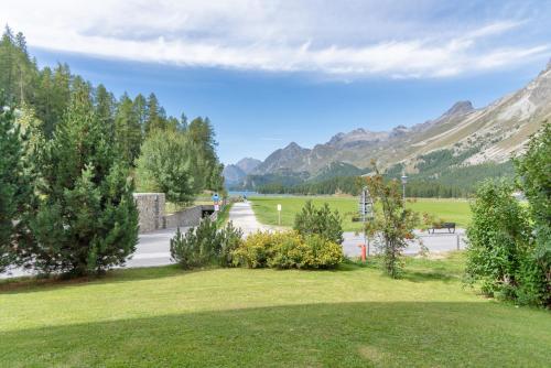 a view of a park with mountains in the background at Chesa Muot Marias - Sils in Sils Maria