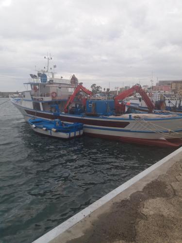 two boats are docked in the water at a dock at Vient e mare (Sea wind) in Torre Annunziata