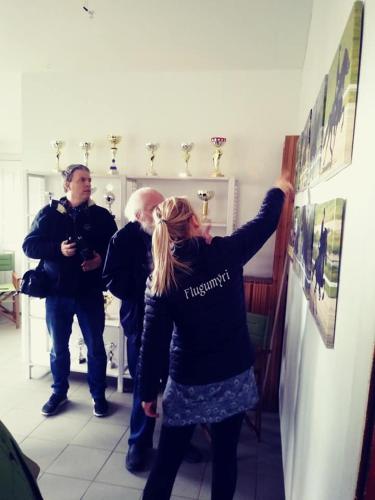 a woman standing in a room pointing to a wall at Flugumýri 2 in Varmahlid