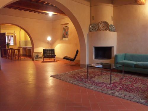 a living room with a couch and a fireplace at B&B Glicine e Luna in Cascina