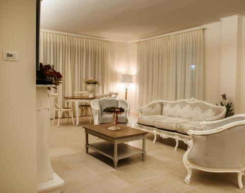 a living room with a couch and chairs and a table at Maralè in Serino