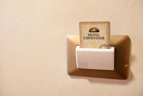 a lightswitch with a book on it on a wall at Hotel Libertador in Santiago