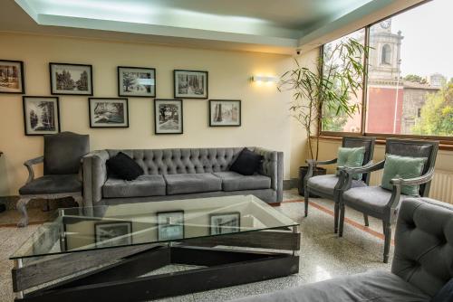 a living room with a couch and a glass coffee table at Hotel Libertador in Santiago