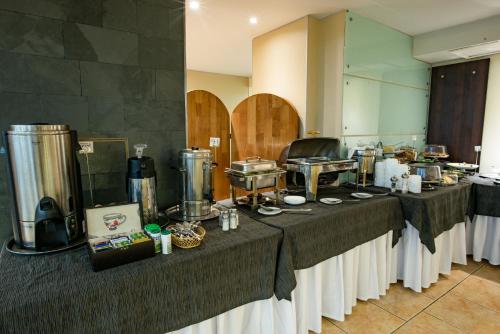 a group of tables in a room with food at Hotel Libertador in Santiago