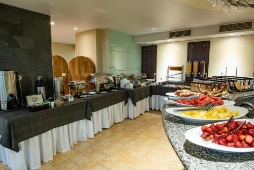 a buffet line with plates of food on them at Hotel Libertador in Santiago