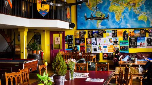 a restaurant with a table and a map of the world on the wall at Castle Rock Hostel - Adults Only in Edinburgh