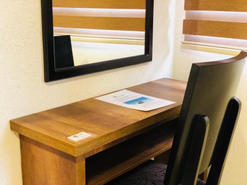 a wooden table with a mirror and a chair at Eco Hotel Katarma in Puerto Baquerizo Moreno