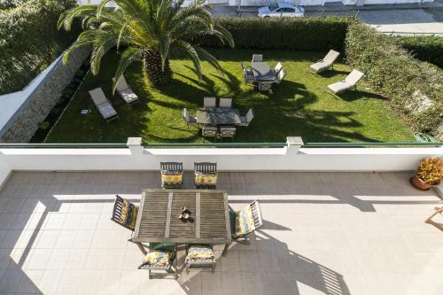 an aerial view of a patio with a table and chairs at Liv In Ericeira Guest House in Ericeira