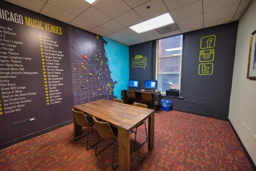 a conference room with a wooden table and chairs at HI Chicago Hostel in Chicago
