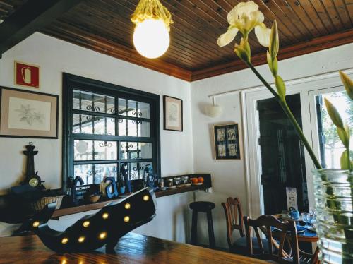 a dining room with a table and a vase with a flower at Zhimbad B&B by the sea in Cala Ratjada