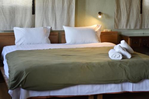 a hotel room with a bed with towels on it at Great Mantineia in Levidhion