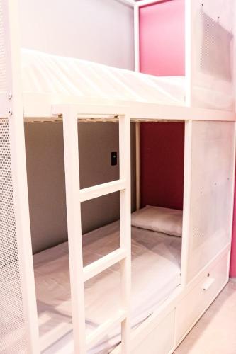 a bunk bed with a ladder in a room at Artsy Vitoria Hostel in Vitória