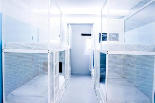 a room with two bunk beds and a hallway at Artsy Vitoria Hostel in Vitória