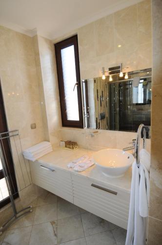 a bathroom with a sink and a mirror at Gold City Premium Private Pool Villa with Free Aqua Park in Alanya