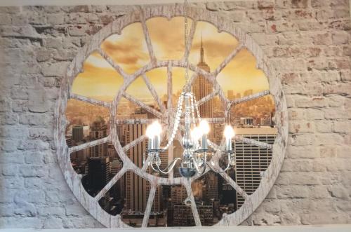 a chandelier in a brick wall with a window at Ferienwohnung Jasmin in Rust
