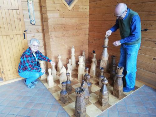 a man and a boy playing a game of chess at Chalet Il Fungo in Averara