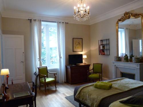 a bedroom with a bed and a mirror and a desk at Chambres d'Hôtes de luxe Côté Parc-Côté Jardin avec parking privé gratuit in Nevers