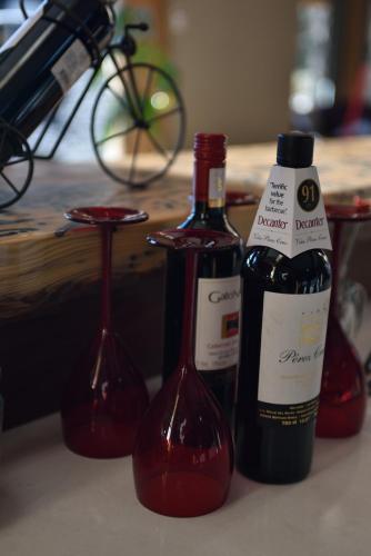 three bottles of red wine sitting on a counter at The Rockwell-Harrison Guest Lodge in Harrison Hot Springs