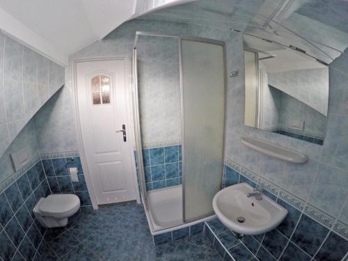 a bathroom with a sink and a toilet and a mirror at Baltic Neptun in Jastrzębia Góra
