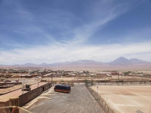 a bus parked in the middle of a desert at Hostal Pablito 2 in San Pedro de Atacama