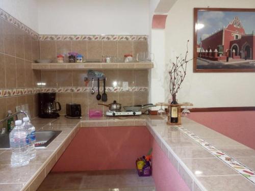 a kitchen with a sink and a counter top at Casa Palagui Colonial in Valladolid