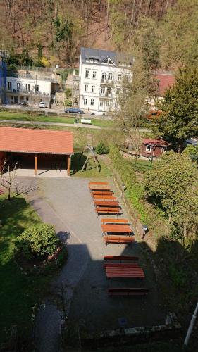 a row of wooden benches in a park at Kurparkstübl Bad Schandau in Bad Schandau