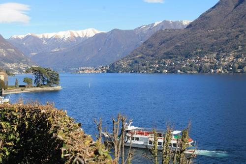 a boat in a large body of water with mountains at Lakeviewcabin in Como