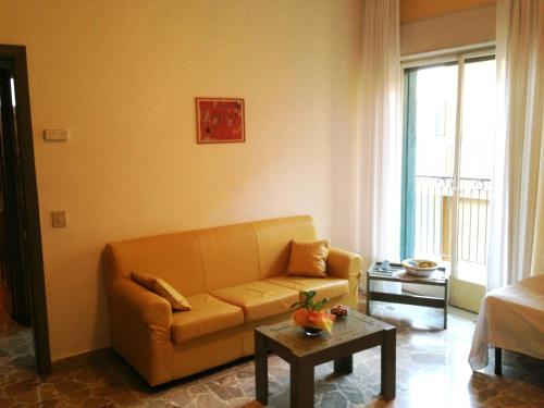 a living room with a couch and a table at Hotel Kennedy in SantʼAlessio Siculo