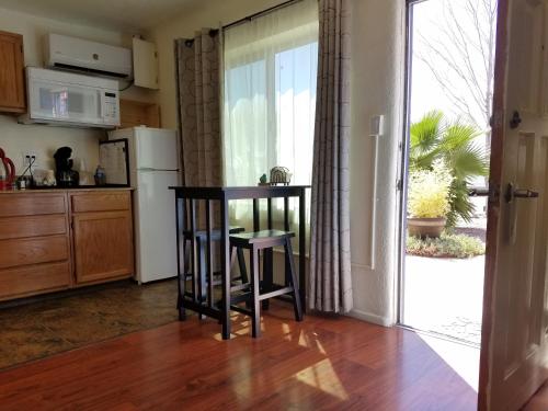 a kitchen with a table and a chair in it at Rocket Inn in Truth or Consequences