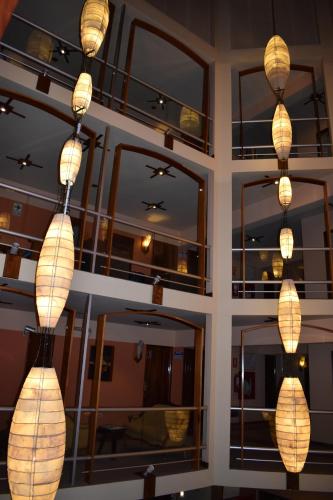 a group of lights hanging in a room with mirrors at Royal Inn Hotel Puno in Puno