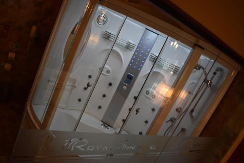 a glass window of a bathroom with a shower at Royal Inn Hotel Puno in Puno